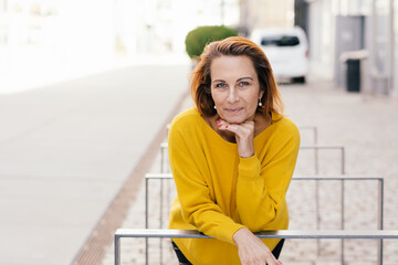 Portrait of smiling woman at city street