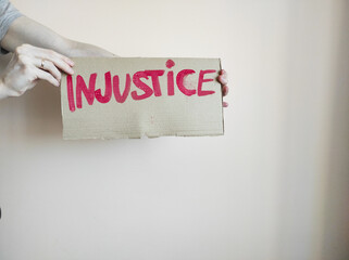 person holding a sign with word Protest written on it
