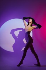 Obraz na płótnie Canvas Beautiful fashionable girl posing studio light neon color background unaltered