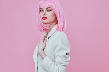 Pretty young female in a suit makeup pink hair posing color background unaltered