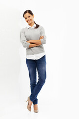 She brightens anywhere with her smile. Studio portrait of an attractive young woman standing with...