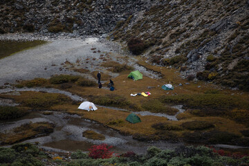 People and tents at camping spot at high altitude 
