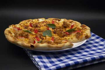Pizza in plate, table view with picnic tablecloth.