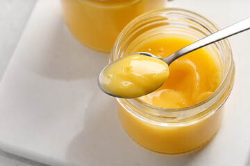 Jar of homemade lemon curd. Lemon curd in a glass jar, dessert with lemon. Lemon Mousse dessert.