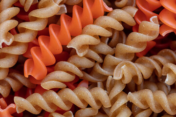 Whole, lentils fusilli pasta background.