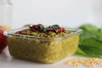 One pot preparation made of basmati rice, yellow mung lentils, blanched and pureed spinach and...