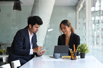 Charming businesswoman  sharing ideas, discussing strategy with her business partner.