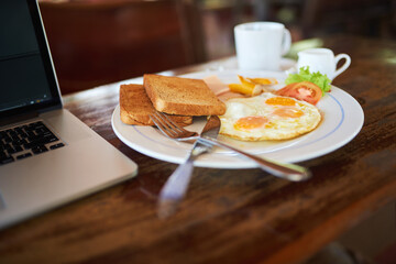 Breakfast connections. High angle shot of freshly made breakfast sitting next to a laptop.