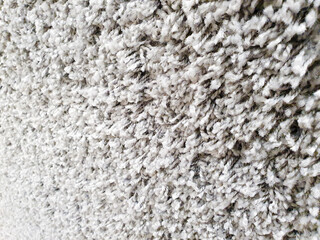 Gray long pile carpet texture background. Polypropylene long pile carpet, close-up