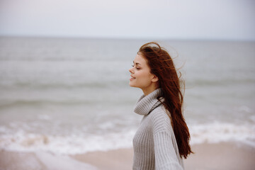 cheerful woman cloudy weather by the sea travel fresh air unaltered