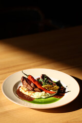 roast beef on puree with pepper and sauce