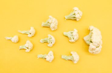 Cauliflower pieces isolated on yellow background, vegetable , top view