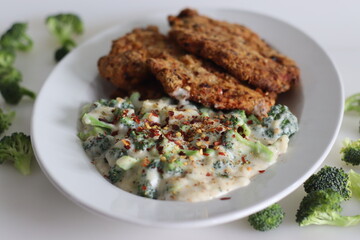 Breaded chicken served with sauteed broccoli in white sauce. Breaded chicken prepared in air fryer