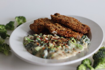 Breaded chicken served with sauteed broccoli in white sauce. Breaded chicken prepared in air fryer