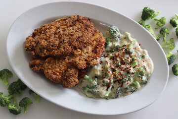 Breaded chicken served with sauteed broccoli in white sauce. Breaded chicken prepared in air fryer