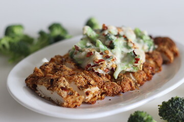 Breaded chicken served with sauteed broccoli in white sauce. Breaded chicken prepared in air fryer