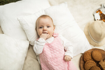 little girl resting on a blanket in the park