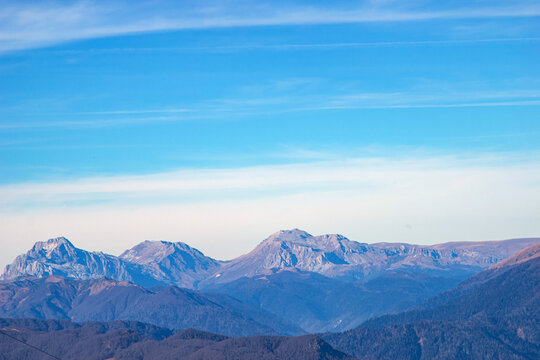 Landscapes in the mountains near Sochi in Russia. High mountain peaks and valleys in the rays of the sun in autumn.
