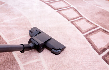 Vacuum cleaner in the room on the carpet, cleanliness in the house, cleaning