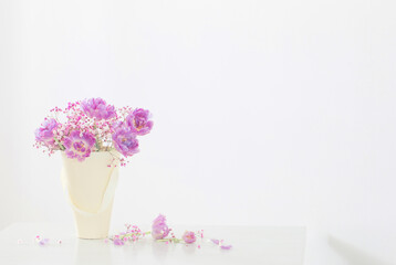 bouquet of pink tulips and gypsophila on white table
