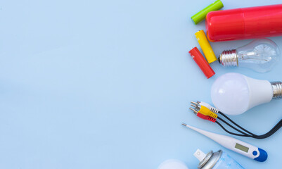 Environmentally hazardous household waste on a light blue background