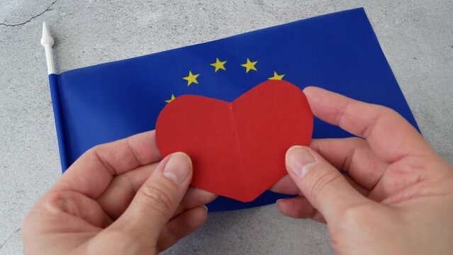 Flag of Europe with red heart symbol, european union flag on gray background, Europe Day 5th and 9th of May, Schumann Declaration day, I love Europe