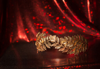 Laurel wreath, crown, symbol of victory on red background.