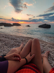 Fototapeta na wymiar couple resting on the beach enjoying view of sunset