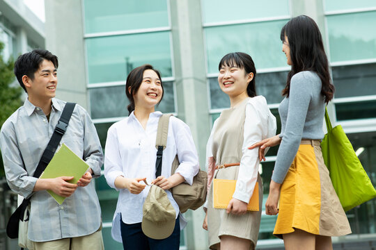 キャンパスで友達と談笑する大学生たち