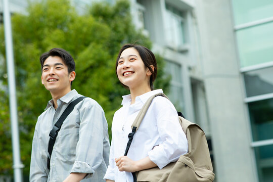 笑顔でキャンバスを歩く男子学生と女子学生