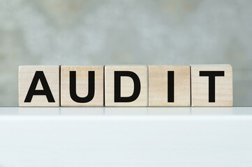 Business and finance concept. A cubes with the inscription - AUDIT