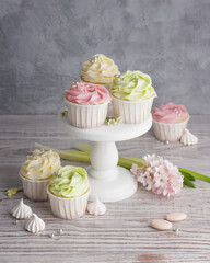 Spring pastel colored cupcakes and flowers