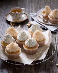 Vanilla cupcakes with pastel colored cream