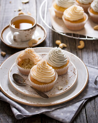 Vanilla cupcakes with pastel colored cream