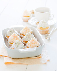 Vanilla cupcakes with pastel colored cream