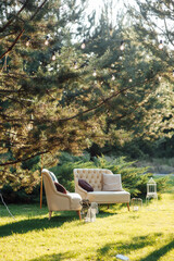 Cozy sofas for relaxing in the garden near the house on the grass. Relax and rest