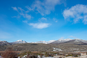 spectacular view of snow-capped mountains with blue skies