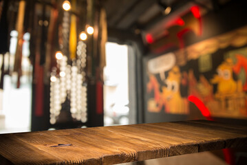 Empty dark wooden table in front of abstract blurred bokeh background of restaurant . can be used for display or montage your products.Mock up for space
