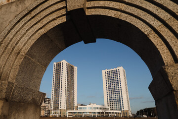 The urban landscape of large city. Exteriors of typical modern apartment buildings against a blue sky with clouds. 