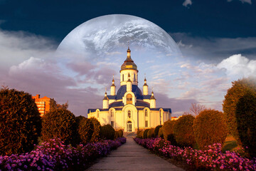 Ukrainian Orthodox Church in Sumy city, against the backdrop of a fantastic sky with a rising planet