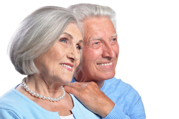 Happy senior couple embracing and posing on white background