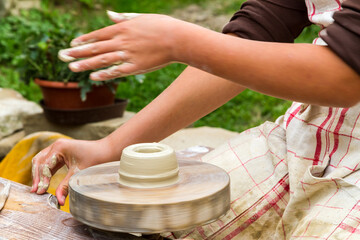 Pottery Artist Using Spinning Wheel Outdoors