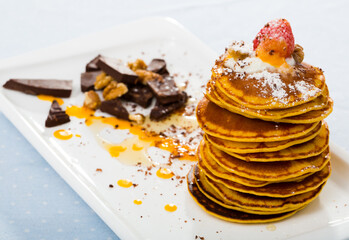 Pumpkin pancakes recipe - mix pumpkin puree with eggs, olive oil, salt, sugar, milk until well combined. Fry in pan without oil. Serve with honey, chocolate, cream, fruits