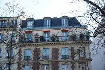 Beautiful facade of a building from Paris, France, with a lot of plants and elegant architecture...