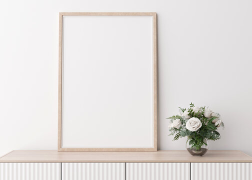 Empty vertical picture frame on white wall in modern living room. Mock up interior in minimalist, scandinavian style. Free space for picture. Console, flowers in vase. 3D rendering.
