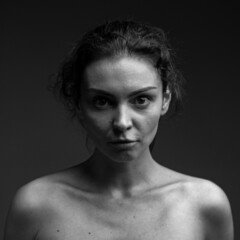 dramatic emotional portrait of a young girl with dark hair.grief emotion