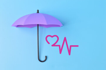 Purple toy umbrella, heart beat and heart shape symbol. Medicine, healthcare and pharmacy concept.