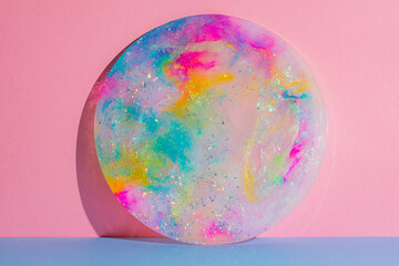 Round circle colourful platter plate on pink and blue background