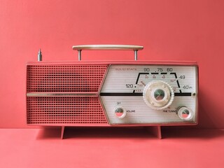 vintage pink transistor radio on pink wall background