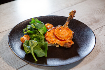 duck leg with sauce and tomato with herbs